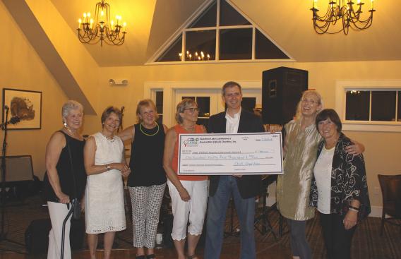 Quechee Lakes Landowners Association Charities present a check to CHaD’s Child Advocacy and Protection Program.