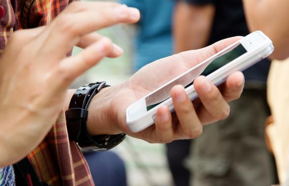 Adolescent using an iPhone