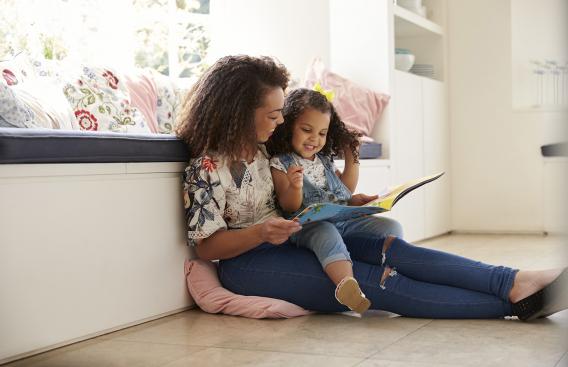 Mother reading to her daughter.