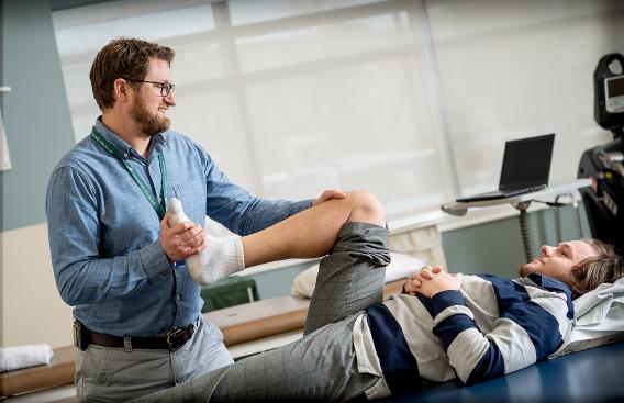 Physical therapist working with patient