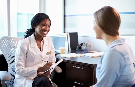 Female teen speaking with doctor.