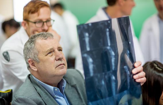 Dr. Rosen holding an X-ray.