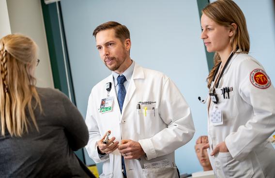 Jason Johns confers with patient