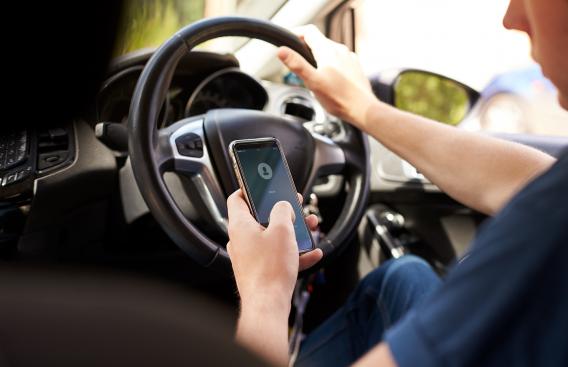 Young man texting and driving
