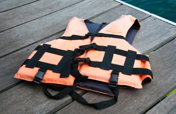 Orange life jacket on a dock.