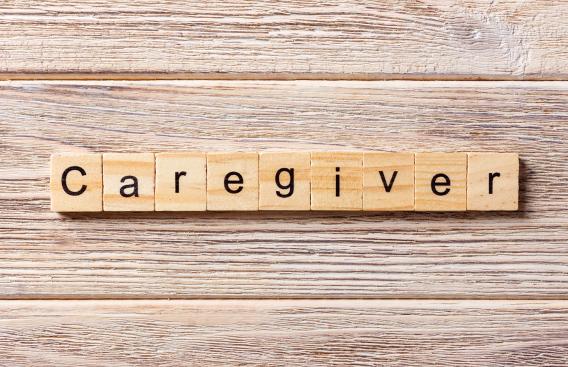 Word caregiver spelled out on Scrabble tiles
