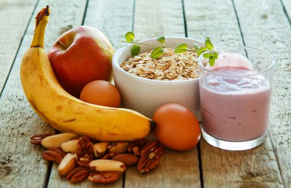 Healthy breakfast options, banana, apple, nuts, oats and yogurt