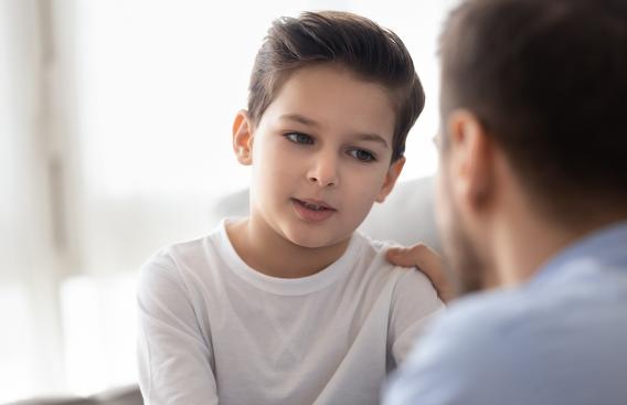 Boy talking with his father.