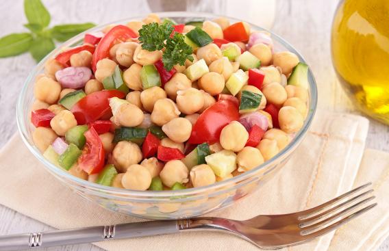 Clear bowl with chickpea, tomatoe, celery and cucumbers