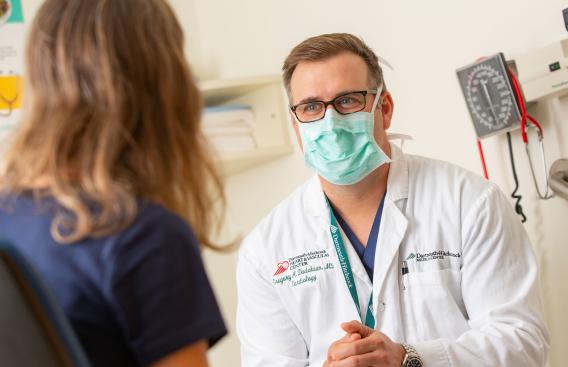 Dr. Dadekian visits with a patient.