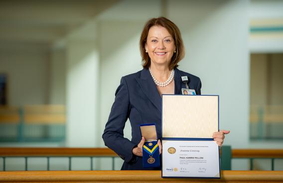 Joanne M. Conory, MD, with Paul Harris Fellowship documents
