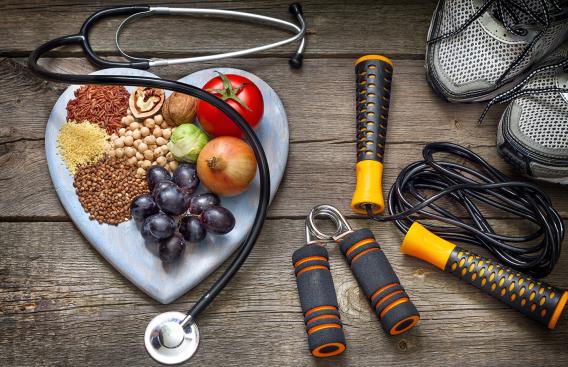 Healthy foods, exercise equipment, and a stethoscope