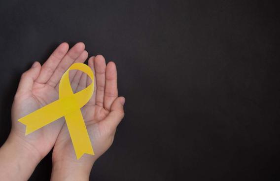 Hands holding a yellow ribbon